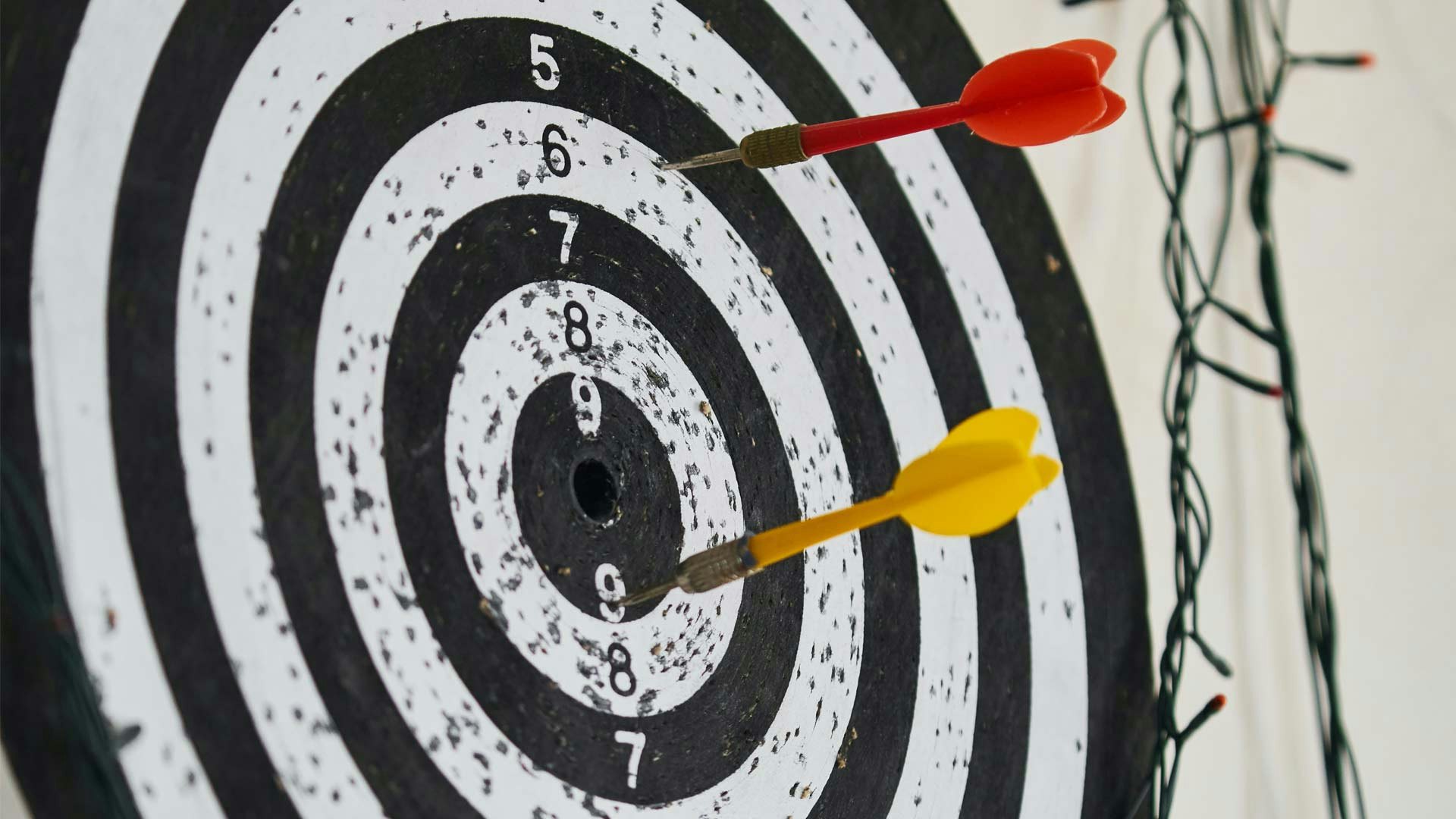 Dart Board with Red and Yellow Darts
